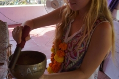 Students practice how to play tibetan singing bowls